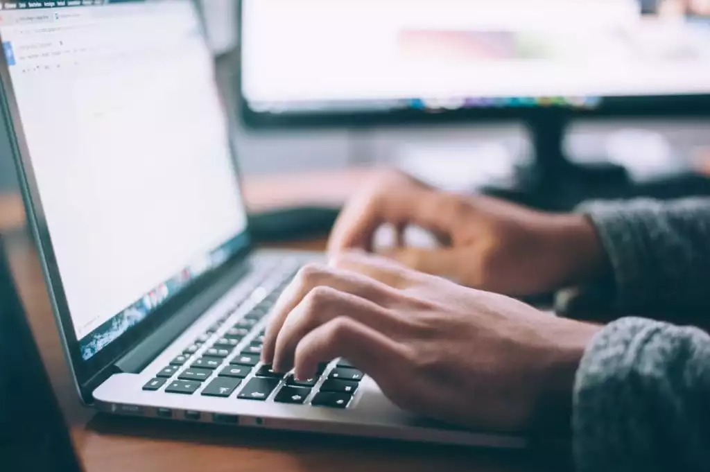 Man's hands on a laptop keyboard